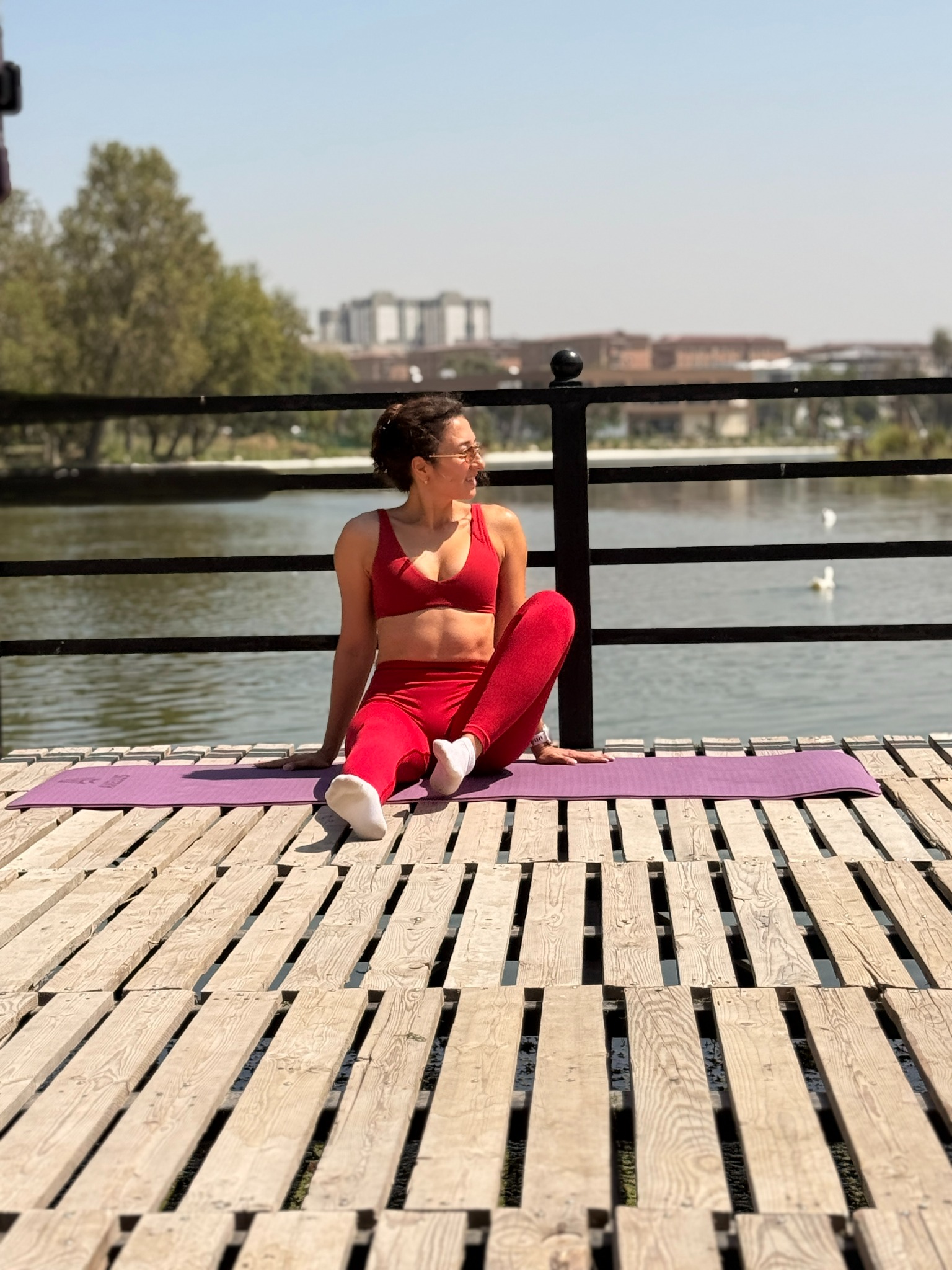 Karina relaxing on her yoga mat outdoors